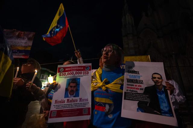 A Venezuelan citizen holds a candlelight during a vigil against Venezuela's President Nicolas Maduro and in support of US President Donald Trump at Lourdes Park in Bogota on December 3, 2025. Venezuela's President Nicolas Maduro confirmed on December 3, 2025, that he had a "cordial" phone call with his US counterpart Donald Trump 10 days ago amid a US military buildup in Latin America. (Photo by Luis ACOSTA / AFP)