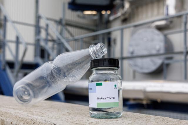 A jar containing the end product and a example of its use of the chemical plants of the UPM Biorefining & Technology are seen in the Leuna Chemical Park near Leuna on November 14, 2025. Finnish materials group UPM unveiled a refinery in the east German state of Saxony-Anhalt in the summer, taking a big risk on a 1.3 billion euro project ($1.5 billion) at a difficult time for the German chemicals sector. (Photo by JENS SCHLUETER / AFP) / TO GO WITH AFP STORY