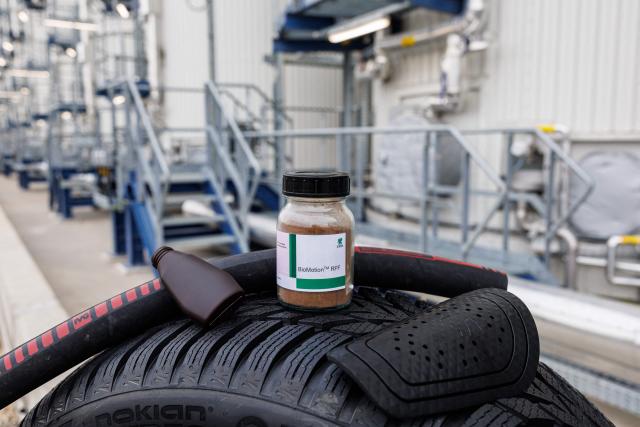 A jar containing the starting product and some examples of how the end product can be used of the chemical plants of the UPM Biorefining & Technology are seen in the Leuna Chemical Park near Leuna on November 14, 2025. Finnish materials group UPM unveiled a refinery in the east German state of Saxony-Anhalt in the summer, taking a big risk on a 1.3 billion euro project ($1.5 billion) at a difficult time for the German chemicals sector. (Photo by JENS SCHLUETER / AFP) / TO GO WITH AFP STORY