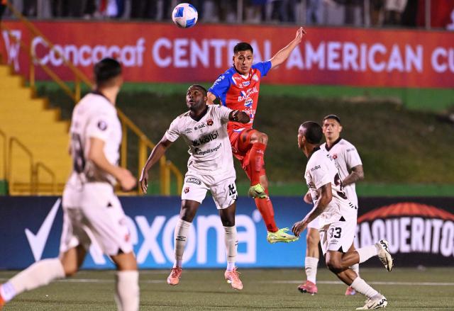 Alajuelense's forward #12 Joel Campbell (L) and Xelaju's midfielder #16 Juan Cardona (R) fight for the ball during the second leg of the CONCACAF Central American Cup final football match between Guatemala's Xelaju and Costa Rica's Alajuelense at Mario Camposeco Stadium in Quetzaltenango, Guatemala, on December 3, 2025. (Photo by JOHAN ORDONEZ / AFP)