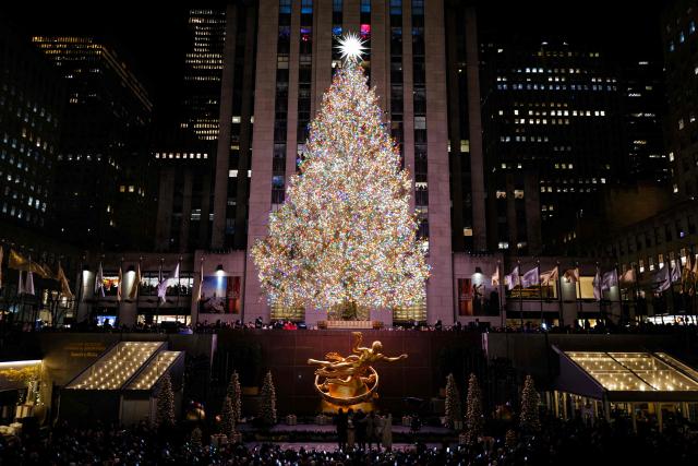The Christmas tree stands illuminated moments after being lit during the Rockefeller Center Christmas Tree Lighting in New York City on December 3, 2025. (Photo by CHARLY TRIBALLEAU / AFP)