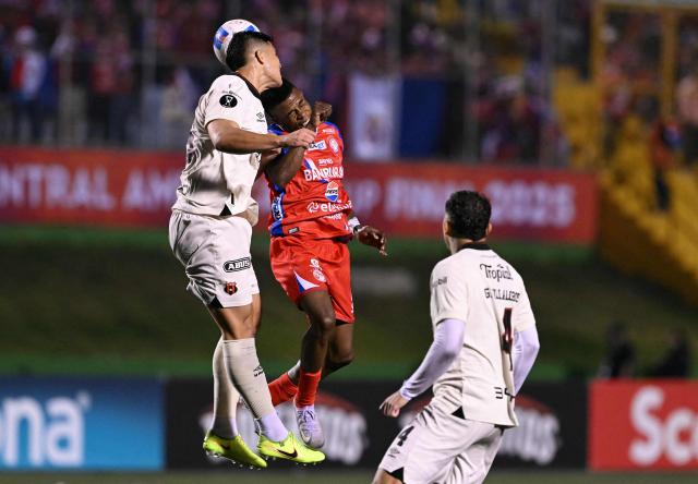 Alajuelense's defender #13 Alexis Gamboa (L) and Xelaju's Colombian midfielder #07 Yilton Diaz (R) fight for the ball during the second leg of the CONCACAF Central American Cup final football match between Guatemala's Xelaju and Costa Rica's Alajuelense at Mario Camposeco Stadium in Quetzaltenango, Guatemala, on December 3, 2025. (Photo by JOHAN ORDONEZ / AFP)