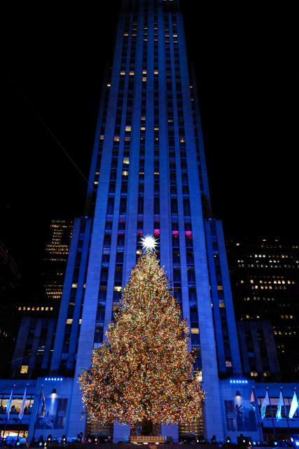 The Christmas tree stands illuminated moments after being lit during the Rockefeller Center Christmas Tree Lighting in New York City on December 3, 2025. (Photo by CHARLY TRIBALLEAU / AFP)