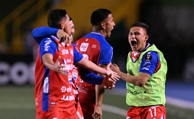 Xelaju's midfielder #16 Juan Cardona (L) celebrates with teammates after scoring his team's first goal during the second leg of the CONCACAF Central American Cup final football match between Guatemala's Xelaju and Costa Rica's Alajuelense at Mario Camposeco Stadium in Quetzaltenango, Guatemala, on December 3, 2025. (Photo by JOHAN ORDONEZ / AFP)