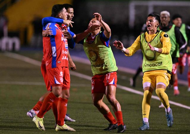 Xelaju's midfielder #16 Juan Cardona (L) celebrates with teammates after scoring his team's first goal during the second leg of the CONCACAF Central American Cup final football match between Guatemala's Xelaju and Costa Rica's Alajuelense at Mario Camposeco Stadium in Quetzaltenango, Guatemala, on December 3, 2025. (Photo by JOHAN ORDONEZ / AFP)