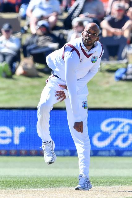 West Indies' Roston Chase bowls during day three of the first Test cricket match between New Zealand and West Indies at Hagley Oval in Christchurch on December 4, 2025. (Photo by Sanka Vidanagama / AFP)