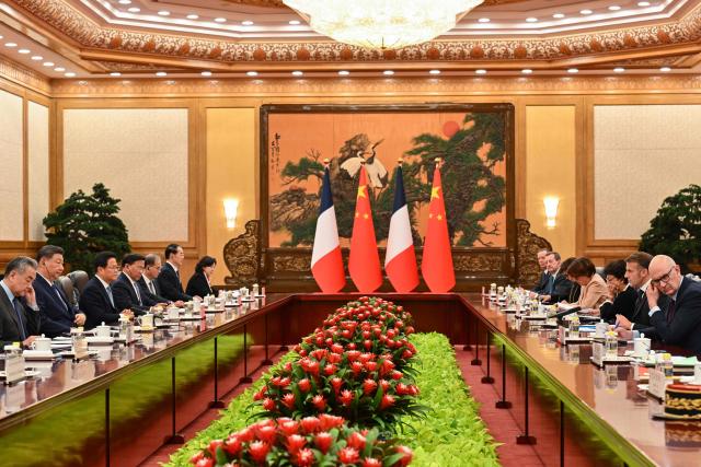 France's President Emmanuel Macron (2nd R) and China's President Xi Jinping (2nd L) hold a bilateral meeting at the Great Hall of the People in Beijing on December 4, 2025. (Photo by Adek BERRY and ADEK BERRY / POOL / AFP)