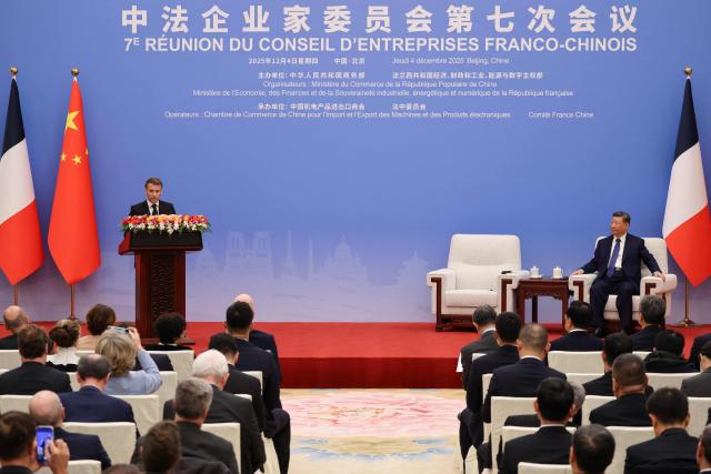 France's President Emmanuel Macron (L) delivers a speech alongside China's President Xi Jinping during the 7th formal meeting of the Franco-Chinese Business Council in Beijing on December 4, 2025. (Photo by Ludovic MARIN / POOL / AFP)