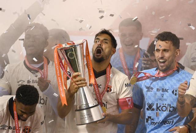 Alajuelense's midfielder #05 Celso Borges lifts the trophy after winning the championship on penalty shoot-out of the CONCACAF Central American Cup final football match between Guatemala's Xelaju and Costa Rica's Alajuelense at Mario Camposeco Stadium in Quetzaltenango, Guatemala, on December 3, 2025. (Photo by Johan ORDONEZ / AFP)