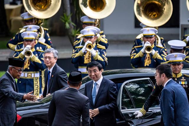 Indonesian State Secretary Minister Prasetyo Hadi (3rd L) greets Chairman of the Chinese People's Political Consultative Conference Wang Huning (C) before a meeting with Indonesia's President Prabowo Subianto at Merdeka Palace in Jakarta on December 4, 2025. (Photo by BAY ISMOYO / AFP)