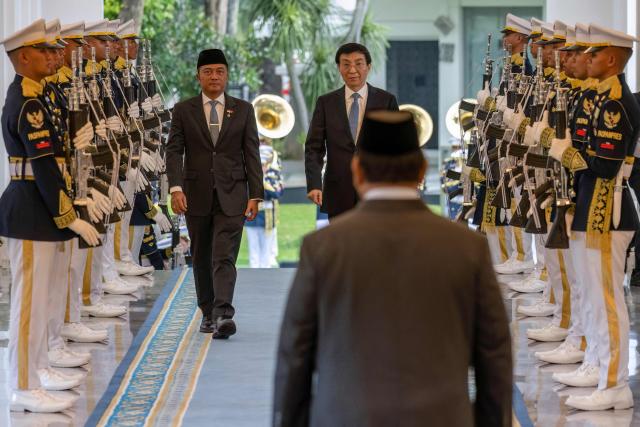 Indonesia's President Prabowo Subianto (R) welcomes Chairman of the Chinese People's Political Consultative Conference Wang Huning before their meeting at Merdeka Palace in Jakarta on December 4, 2025. (Photo by BAY ISMOYO / AFP)
