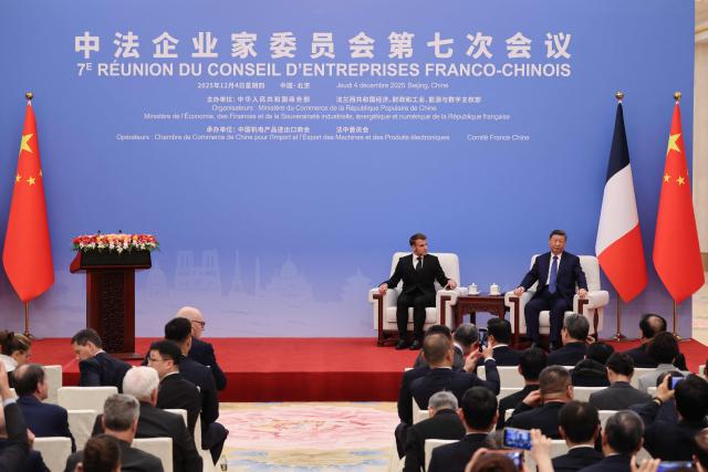 France's President Emmanuel Macron and China's President Xi Jinping attend the 7th formal meeting of the Franco-Chinese Business Council in Beijing on December 4, 2025. (Photo by Ludovic MARIN / POOL / AFP)