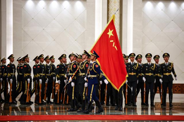Chinese honour guards prepare for a welcome ceremony for France's President Emmanuel Macron at the Great Hall of the People in Beijing on December 4, 2025. (Photo by Sarah Meyssonnier / POOL / AFP)