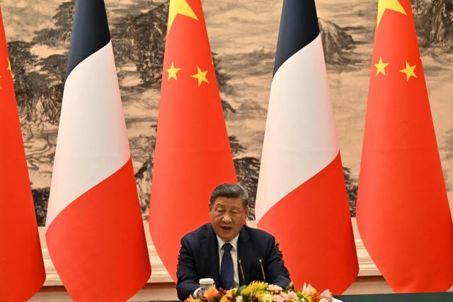 China's President Xi Jinping and France's President Emmanuel Macron (not pictured) deliver a joint statement to the press following meetings and a signing ceremony for agreements at the Great Hall of the People in Beijing on December 4, 2025. (Photo by Adek BERRY and ADEK BERRY / POOL / AFP)