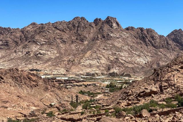 This picture taken on July 6, 2025, shows hotels under construction in the Saint Catherine valley near the peak of Mount Sinai, also known as Jebel Moussa. In the remote, rugged terrain of southern Sinai, Egypt has undertaken a vast megaproject aimed at drawing mass tourism to the once serene mountain town of Saint Catherine. Heritage experts and locals say the state's bulldozers have already damaged the nature reserve and UNESCO world heritage site, home to the world's oldest functioning Christian monastery and Bedouin who fear for their ancestral land. (Photo by Bahira AMIN / AFP)