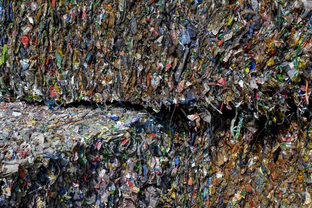 This photo taken on November 25, 2025, shows bundles of plastic waste in a village on the outskirts of Hanoi. (Photo by Nhac NGUYEN / AFP)