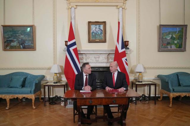 Norway's Defence Minister Tore O. Sandvik (L) speaks with Britain's Defence Secretary John Healey (R) during the signing of a strategic defence agreement in London on December 4, 2025. (Photo by Alastair Grant / POOL / AFP)