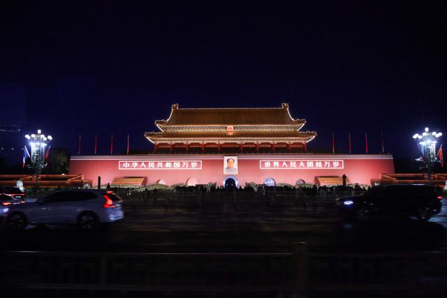 The national flags of France and China are displayed on posts near a portrait of the late communist leader Mao Zedong at Tiananmen Square during a visit by France's President Emmanuel Macron in Beijing on December 4, 2025. (Photo by Ludovic MARIN / AFP)