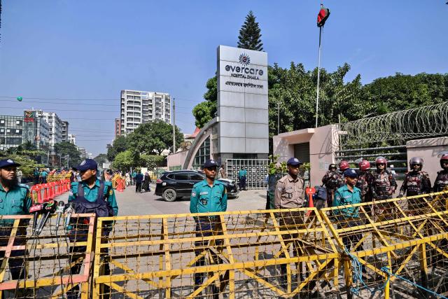 Border Guard Bangladesh (BGB) and police personnel stand guard outside a hospital where Bangladesh's ex-prime minister Khaleda Zia was admitted in Dhaka on December 4, 2025. (Photo by Munir UZ ZAMAN / AFP)