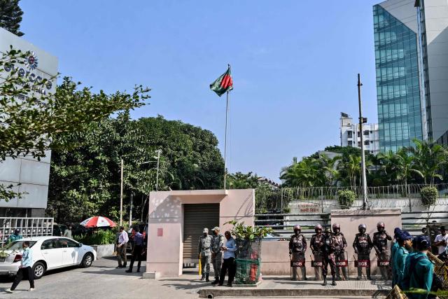 Border Guard Bangladesh (BGB) and police personnel stand guard outside a hospital where Bangladesh's ex-prime minister Khaleda Zia was admitted in Dhaka on December 4, 2025. (Photo by Munir UZ ZAMAN / AFP)