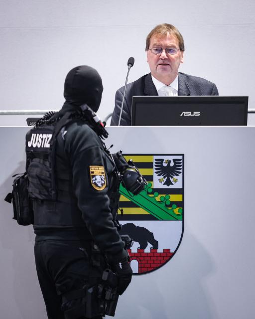 Presiding judge Dirk Sternberg (R) chats with an judicial security officer in the temporary courtroom in Magdeburg, eastern Germany on December 4, 2025, during the trial against Saudi Arabian defendant Taleb Jawad al-Abdulmohsen over the deadly Christmas market attack in December 2024. The Saudi doctor went on trial accused of driving an SUV through a Christmas market, killing six people and wounding more than 300. Taleb Jawad al-Abdulmohsen, a 51-year-old psychiatrist, was arrested next to the battered rental vehicle after the attack on December 20, 2024 in the eastern city of Magdeburg. (Photo by RONNY HARTMANN / AFP)