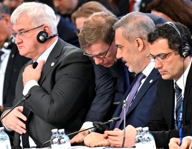 CORRECTION / German Foreign Minister Johann Wadephul (2nd,L) speaks with Turkish Foreign Minister Hakan Fidan (2nd,R) next to Ukrainian Foreign minister Andrii Sybiha (L) attending a Ministerial Council meeting of the Oranization for Security and Co-operation in Europe (OSCE) on December 4, 2025 in Vienna, Austria. (Photo by HANS KLAUS TECHT / APA / AFP) / Austria OUT / The erroneous mention[s] appearing in the metadata of this photo by HANS KLAUS TECHT has been modified in AFP systems in the following manner: [German Foreign Minister Johann Wadephul (2nd,L) speaks with Turkish Foreign Minister Hakan Fidan (2nd,R) next to Ukrainian Foreign minister Andrii Sybiha (L)] instead of [speaks with Ukrainian Foreign Minister]. Please immediately remove the erroneous mention[s] from all your online services and delete it (them) from your servers. If you have been authorized by AFP to distribute it (them) to third parties, please ensure that the same actions are carried out by them. Failure to promptly comply with these instructions will entail liability on your part for any continued or post notification usage. Therefore we thank you very much for all your attention and prompt action. We are sorry for the inconvenience this notification may cause and remain at your disposal for any further information you may require.