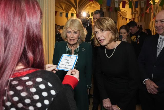 Britain's Queen Camilla (C) and Elke Budenbender (centre R), wife of Germany's President Frank-Walter Steinmeier, meet volunteers from "Citizen Hub" during a reception for volunteering charities at Windsor Castle in Windsor on December 4, 2025, on the second day of a three-day state visit by the German president. (Photo by Aaron Chown / POOL / AFP)