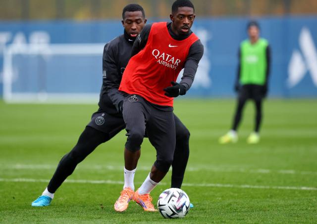 Paris Saint-Germain's French forward #10 Ousmane Dembele plays the ball next to Paris Saint-Germain's Ecuadoran defender #51 Willian Pacho (L) during a training session in Poissy, west of Paris, on December 4, 2025, two days ahead of the French L1 football match between against Rennes. (Photo by FRANCK FIFE / AFP)
