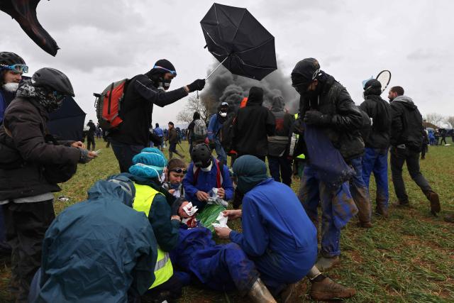 (FILES) A wounded protester is under care during a demonstration called by the collective "Bassines non merci", the environmental movement "Les Soulevements de la Terre" and the French trade union 'Confederation paysanne' to protest against the construction of a new water reserve for agricultural irrigation, in Sainte-Soline, central-western France, on March 25, 2023. The public prosecutor's office opens a judicial investigation into the “direct fire” by gendarme officers during March 25, 2023's protest, on December 4, 2025. (Photo by Thibaud MORITZ / AFP)