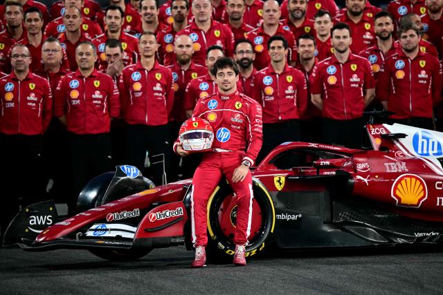 Ferrari's Monaco driver Charles Leclerc and the team pose for a group photo ahead of the Abu Dhabi Formula One Grand Prix at the Yas Marina Circuit in Abu Dhabi on December 4, 2025. (Photo by Giuseppe CACACE / AFP)