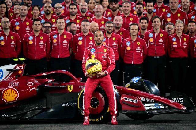 Ferrari's British driver Lewis Hamilton and the team pose for a group photo ahead of the Abu Dhabi Formula One Grand Prix at the Yas Marina Circuit in Abu Dhabi on December 4, 2025. (Photo by Giuseppe CACACE / AFP)