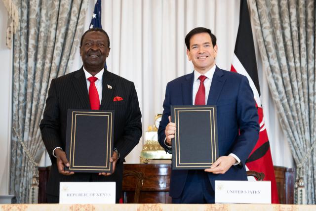 US Secretary of State Marco Rubio (R) and Kenyan Prime Cabinet Secretary Musalia Mudavadi (L) participate in a Health Framework of Cooperation signing ceremony at the State Department in Washington, DC on December 4, 2025. The United States on Thursday signed a $2.5 billion health aid deal with Kenya, the first such bilateral agreement after President Donald Trump tore down the historic US aid agency and sidelined NGOs. Trump administration officials said the agreement would be the first in a series of agreements with developing countries' governments, which will be asked to share the bill and cooperate with Washington on other priorities. (Photo by Allison ROBBERT / AFP)