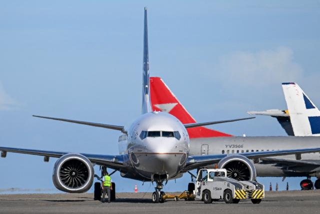 A Copa Airlines plane is seen at the Simon Bolivar International Airport in Maiquetia, Venezuela, on December 3, 2025. Panamanian airlines Copa Airlines and Wingo suspended flights to and from Venezuela on December 3 for two days, joining eight other carriers in a temporary halt following a warning from the U.S. aviation authority about increased military activity in the Caribbean. (Photo by Juan BARRETO / AFP)