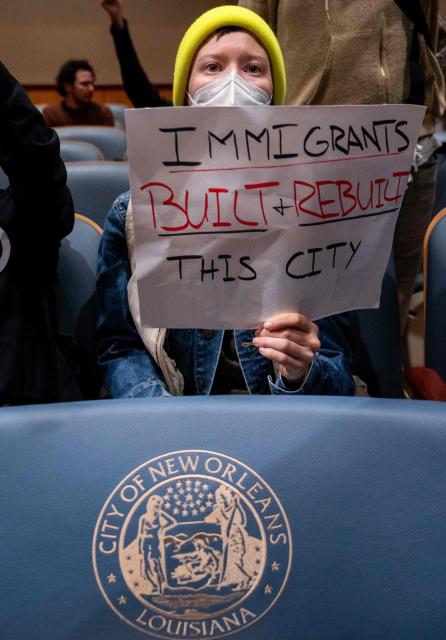 Anti-ICE and Border Patrol protestors disrupt a city council meeting before being removed by New Orleans Police Department officers at City Hall in New Orleans, Louisiana, on December 4, 2025. The US Department of Homeland Security announced on December 3 it has launched a federal immigration enforcement operation, named "Operation Catahoula Crunch," in the New Orleans, Louisiana, area. (Photo by Adam GRAY / AFP)