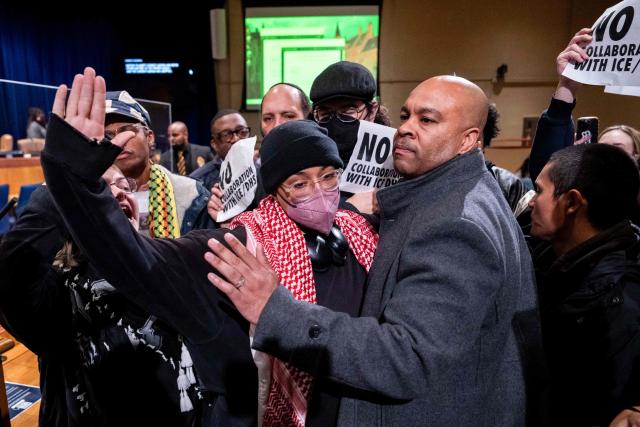 Anti-ICE and Border Patrol protestors disrupt a city council meeting before being removed by New Orleans Police Department officers at City Hall in New Orleans, Louisiana, on December 4, 2025. The US Department of Homeland Security announced on December 3 it has launched a federal immigration enforcement operation, named "Operation Catahoula Crunch," in the New Orleans, Louisiana, area. (Photo by Adam GRAY / AFP)
