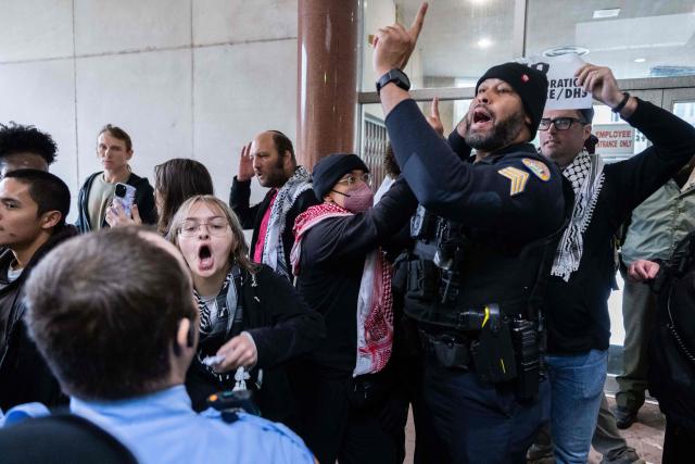 Anti-ICE and Border Patrol protestors are removed from City Hall by New Orleans Police Department officers after disrupting a city council meeting in New Orleans, Louisiana, on December 4, 2025. The US Department of Homeland Security announced on December 3 it has launched a federal immigration enforcement operation, named "Operation Catahoula Crunch," in the New Orleans, Louisiana, area. (Photo by Adam GRAY / AFP)