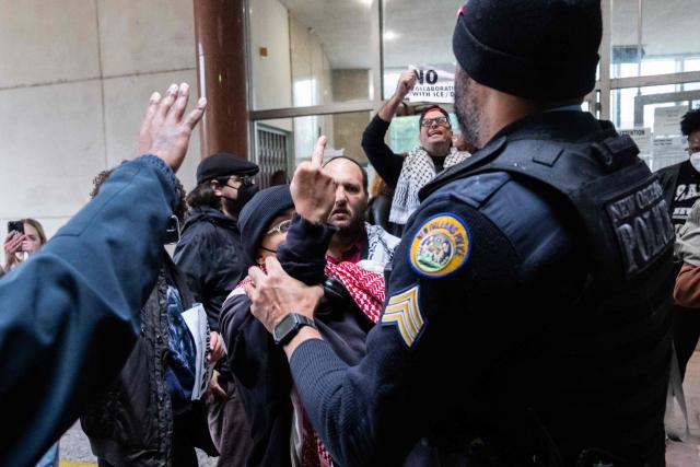 Anti-ICE and Border Patrol protestors are removed City Hall by New Orleans Police Department officers after disrupting a city council meeting in New Orleans, Louisiana, on December 4, 2025. The US Department of Homeland Security announced on December 3 it has launched a federal immigration enforcement operation, named "Operation Catahoula Crunch," in the New Orleans, Louisiana, area. (Photo by Adam GRAY / AFP)
