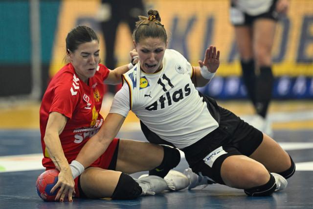 Montenegro's left back #95 Ilda Kepic and Germany's left back #11 Xenia Smits vie for the ball during the main round - Day 5 Group II handball match Montenegro v Germany of the IHF Women's Handball World Championship in Dortmund, western Germany on December 4, 2025. (Photo by INA FASSBENDER / AFP)