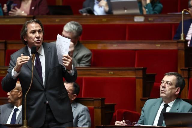 Socialistes et Apparentes' MP Jerome Guedj (L) speaks during a session devoted to the second reading of the 2026 social security budget bill (PLFSS) at the National Assembly, the French Parliament lower house, in Paris on December 4, 2025. (Photo by Anne-Christine POUJOULAT / AFP)