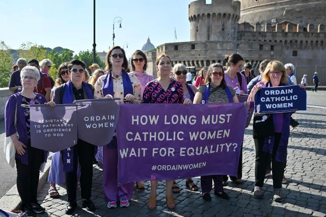 (FILES) Supporters of Women's Ordination Conference (WOC), demonstrate to advocate and pray for the ordination of women as deacons, priests, and bishops into an inclusive and accountable Roman Catholic Church, near the Vatican in Rome, on October 6, 2023. A Vatican commission has yet to take a firm decision on whether women could become deacons, but the answer for now remains no, according to a document made public on December 4, 2025. (Photo by Filippo MONTEFORTE / AFP)