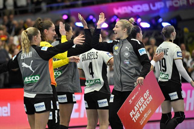 Germany's players of the match, Germany's goalkeeper #42 Katharina Filter celebrate with her team mates after winning the main round - Day 5 Group II handball match Montenegro v Germany of the IHF Women's Handball World Championship in Dortmund, western Germany on December 4, 2025. (Photo by INA FASSBENDER / AFP)