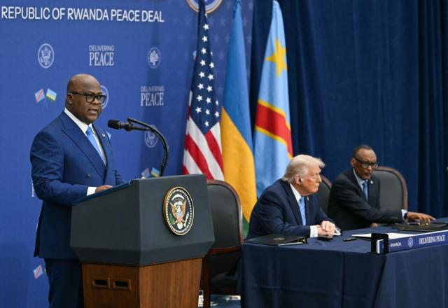 The Democratic Republic of the Congo's President Felix Tshisekedi (L) speaks as US President Donald Trump (C) and Rwanda's President Paul Kagame (R) listen during signing ceremony for a peace deal between Rwanda and the Democratic Republic of the Congo at the United States Institute of Peace in Washington, DC, on December 4, 2025. Trump on Thursday brings the leaders of Rwanda and the Democratic Republic of Congo together to endorse a deal that Trump has hailed as his latest peace triumph despite ongoing violence on the ground. Trump hopes the agreement will pave the way for the United States to gain access to critical minerals in the eastern DRC, a violence-torn region home to many of the key ingredients in modern technologies such as electric cars. (Photo by ANDREW CABALLERO-REYNOLDS / AFP)