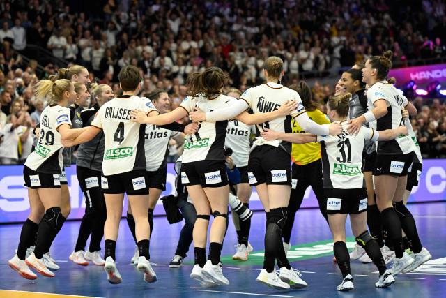 Germany's players celebrate after winning the main round - Day 5 Group II handball match Montenegro v Germany of the IHF Women's Handball World Championship in Dortmund, western Germany on December 4, 2025. (Photo by INA FASSBENDER / AFP)