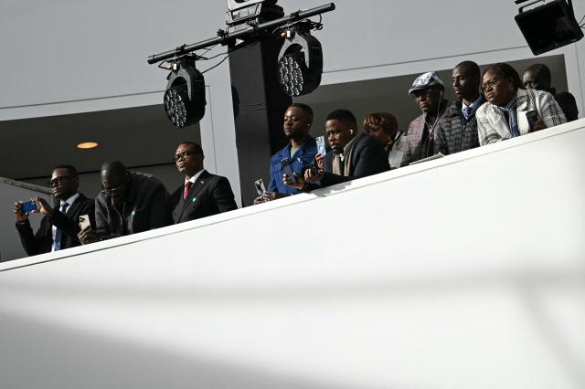 Attendees watch as US President Donald Trump hosts a signing ceremony of a peace deal with the President of Rwanda Paul Kagame and the President of the Democratic Republic of the Congo Felix Tshisekedi at the United States Institute of Peace in Washington, DC, on December 4, 2025. Trump on Thursday brings the leaders of Rwanda and the Democratic Republic of Congo together to endorse a deal that Trump has hailed as his latest peace triumph despite ongoing violence on the ground. Trump hopes the agreement will pave the way for the United States to gain access to critical minerals in the eastern DRC, a violence-torn region home to many of the key ingredients in modern technologies such as electric cars. (Photo by ANDREW CABALLERO-REYNOLDS / AFP)