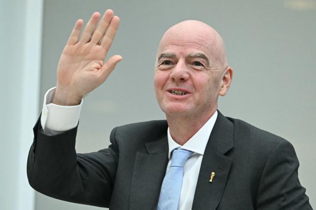FIFA President Gianni Infantino stands as he is recognized during a signing ceremony hosted by US President Donald Trump for a peace deal between Rwanda and the Democratic Republic of the Congo at the United States Institute of Peace in Washington, DC, on December 4, 2025. Trump on Thursday brings the leaders of Rwanda and the Democratic Republic of Congo together to endorse a deal that Trump has hailed as his latest peace triumph despite ongoing violence on the ground. Trump hopes the agreement will pave the way for the United States to gain access to critical minerals in the eastern DRC, a violence-torn region home to many of the key ingredients in modern technologies such as electric cars. (Photo by ANDREW CABALLERO-REYNOLDS / AFP)