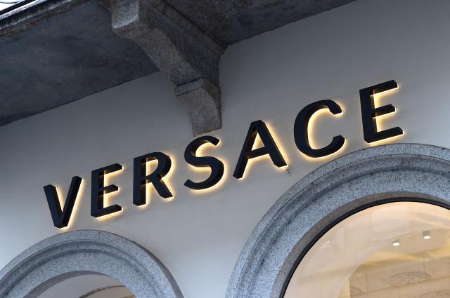 (FILES) A picture shows the logo of Italian fashion shop Versace on December 4, 2017, in via Montenapoleone, a high-class shopping district in Milan. Italian fashion brand Versace announced the departure of its chief creative officer, Dario Vitale, on December 4, 2025, less than nine months after he took over from Donatella Versace. (Photo by MIGUEL MEDINA / AFP)