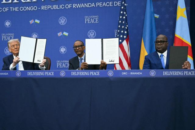 US President Donald Trump (L) participates in the signing ceremony of a peace deal with the President of Rwanda Paul Kagame and the President of the Democratic Republic of the Congo Felix Tshisekedi at the United States Institute of Peace in Washington, DC, on December 4, 2025. Trump on Thursday brings the leaders of Rwanda and the Democratic Republic of Congo together to endorse a deal that Trump has hailed as his latest peace triumph despite ongoing violence on the ground. Trump hopes the agreement will pave the way for the United States to gain access to critical minerals in the eastern DRC, a violence-torn region home to many of the key ingredients in modern technologies such as electric cars. (Photo by ANDREW CABALLERO-REYNOLDS / AFP)
