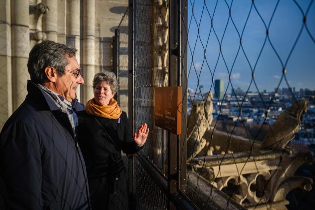 France's Trade Minister Serge Papin looks at the city of Paris from a high view point on Notre-Dame de Paris Cathedral, on December 4, 2025. (Photo by Dimitar DILKOFF / AFP)