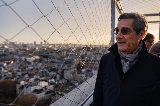 France's Trade Minister Serge Papin looks at the city of Paris from a high view point on Notre-Dame de Paris Cathedral, on December 4, 2025. (Photo by Dimitar DILKOFF / AFP)