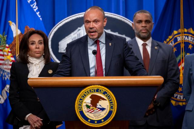 Deputy FBI Director Dan Bongino (C) speaks during a news conference at the Department of Justice to discuss the arrest of man in connection with pipe bombs placed near the Democratic and Republican party headquarters on the eve of the January 6, 2021 US Capitol riot,  in Washington, DC, on December 4, 2025. (Photo by DANIEL HEUER / AFP)